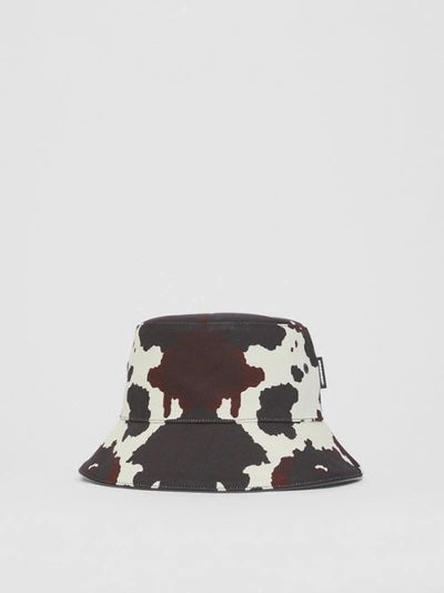 BURBERRY LOGO PATCH COW PRINT BUCKET HAT
